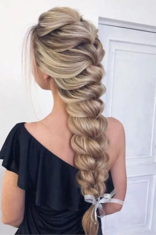 Professional styling with elegant hair braiding.