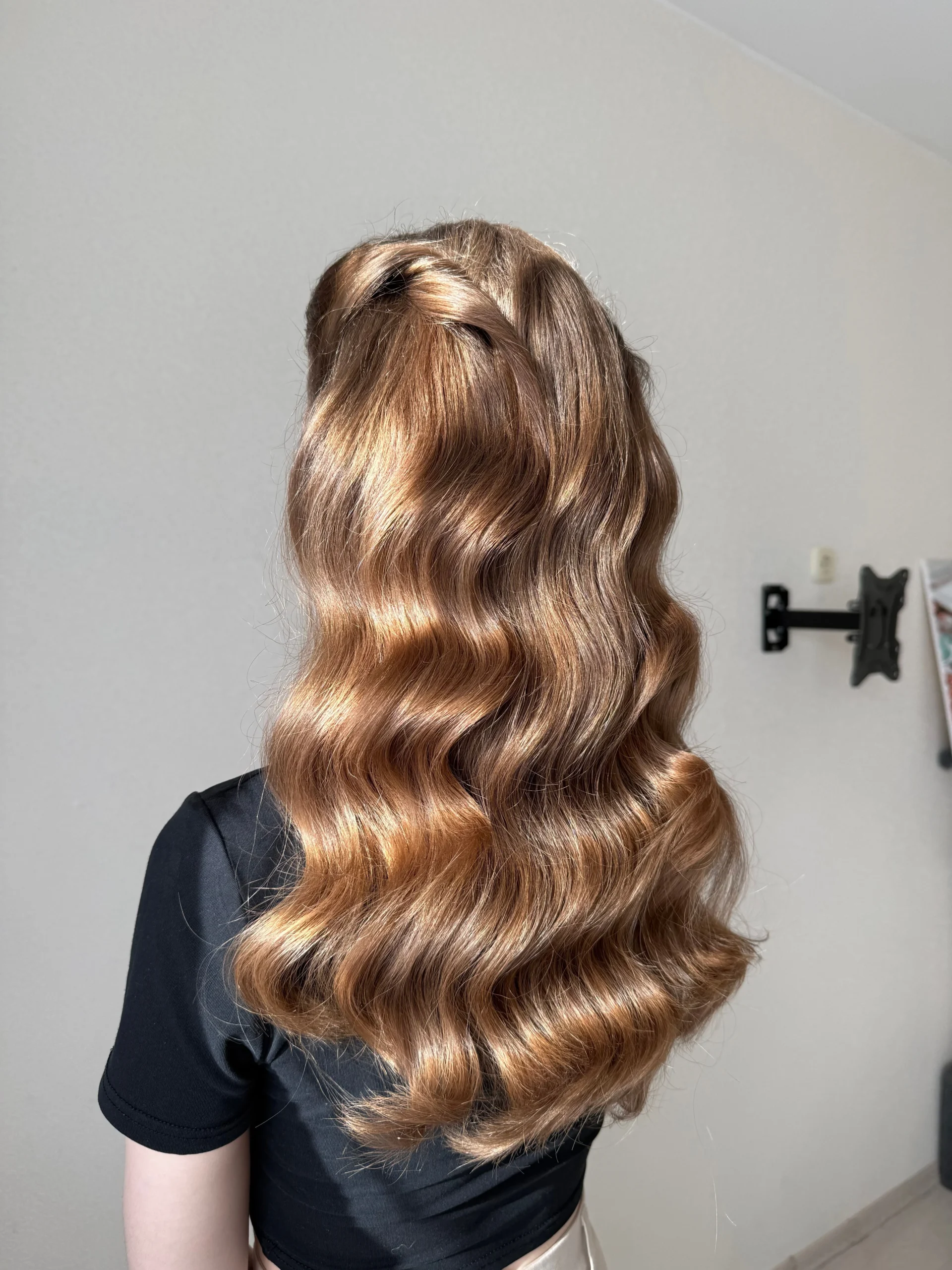 Hair prepared for an event with professional hairstyling.