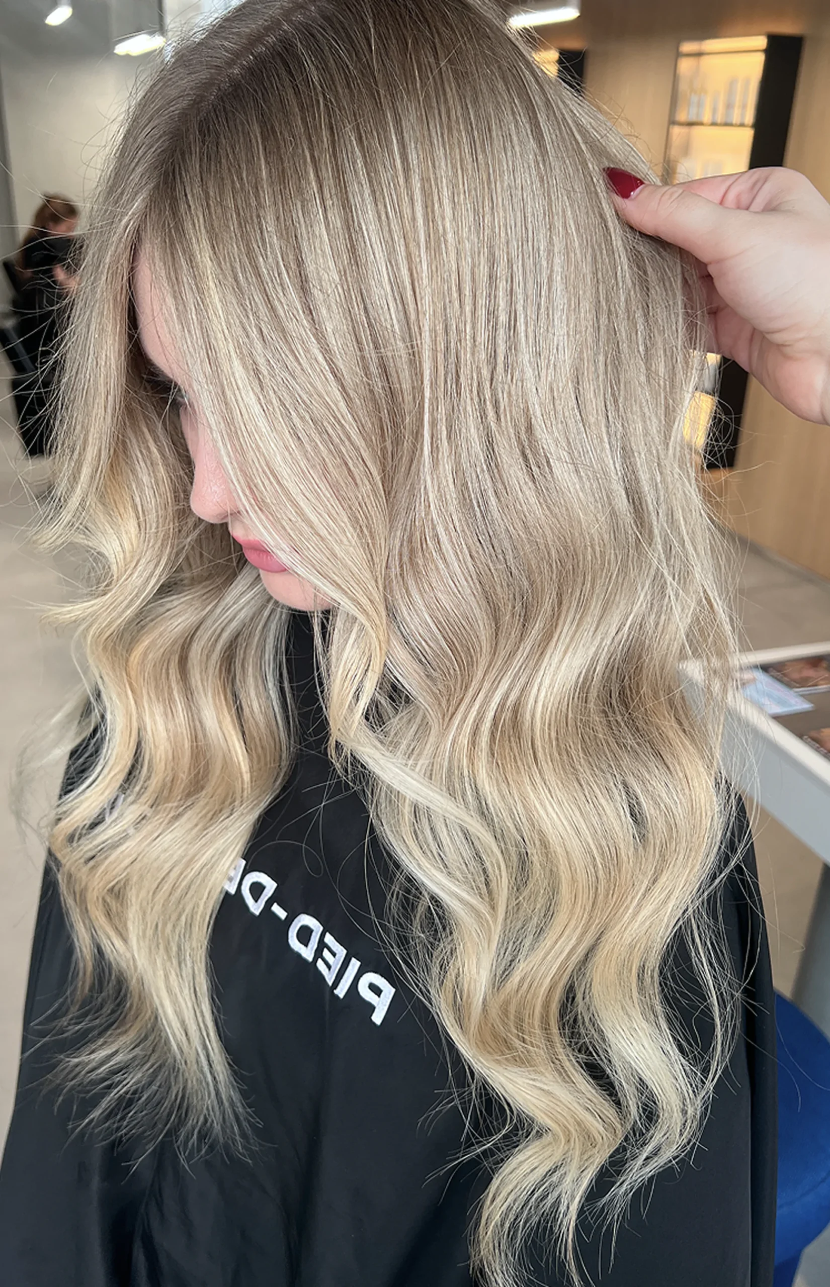 A polished hairstyle completed with hair coloring services.