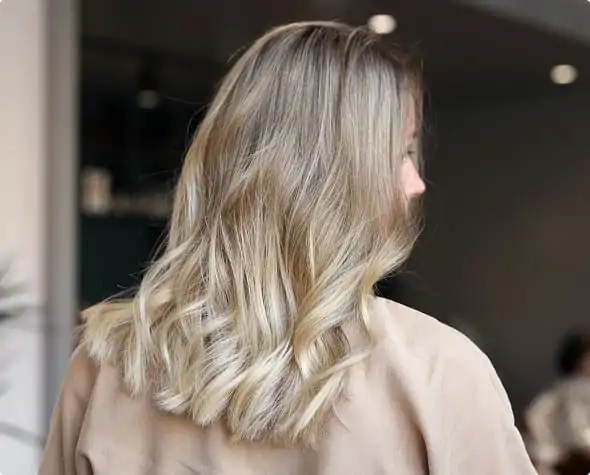Elegant styling enhanced with hair highlights.