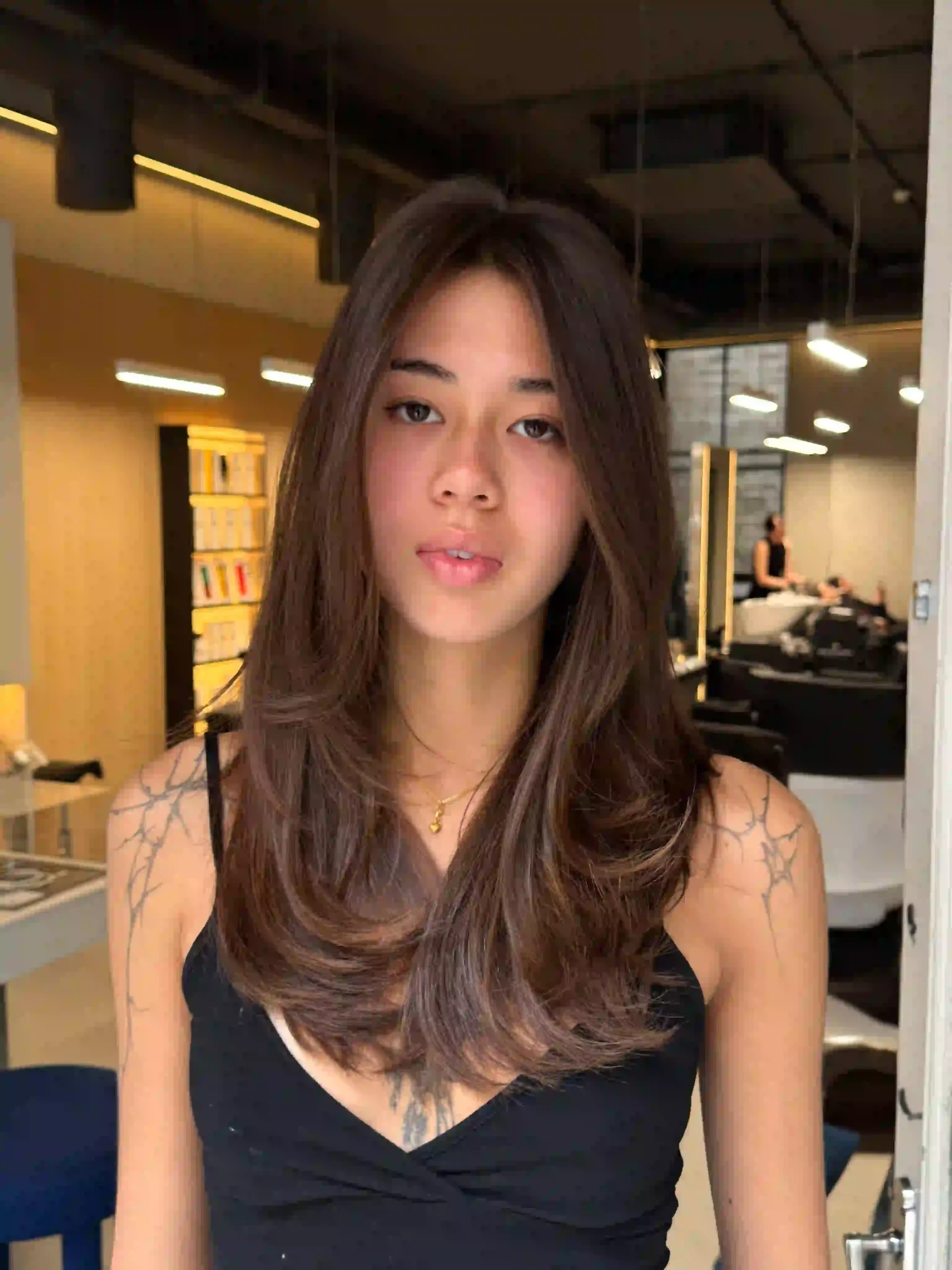 Ice hair extensions – long brown hair styled in soft, voluminous waves
