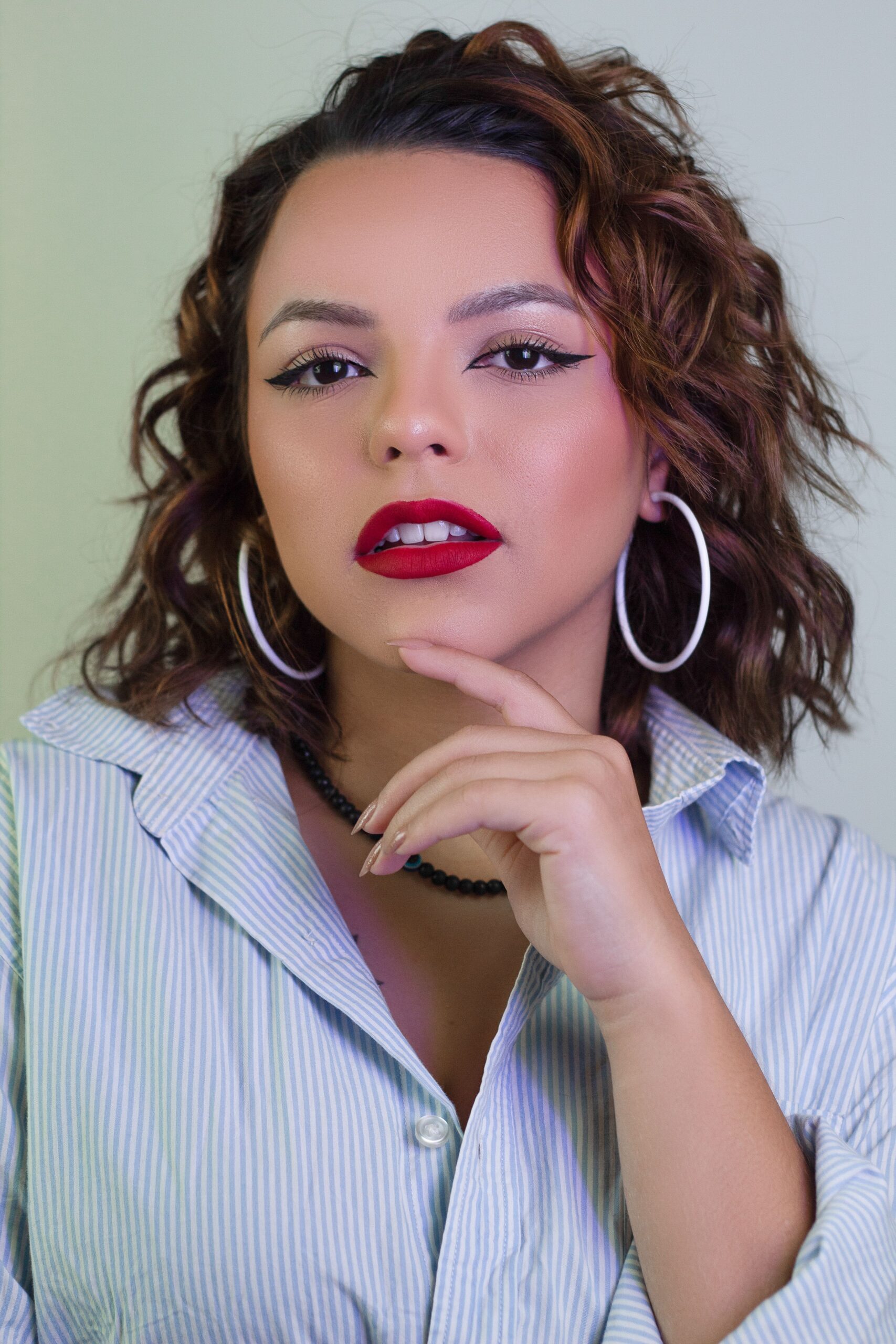 Beauty portrait featuring expertly blended foundation, defined cheekbones, long lashes, and soft pink lips