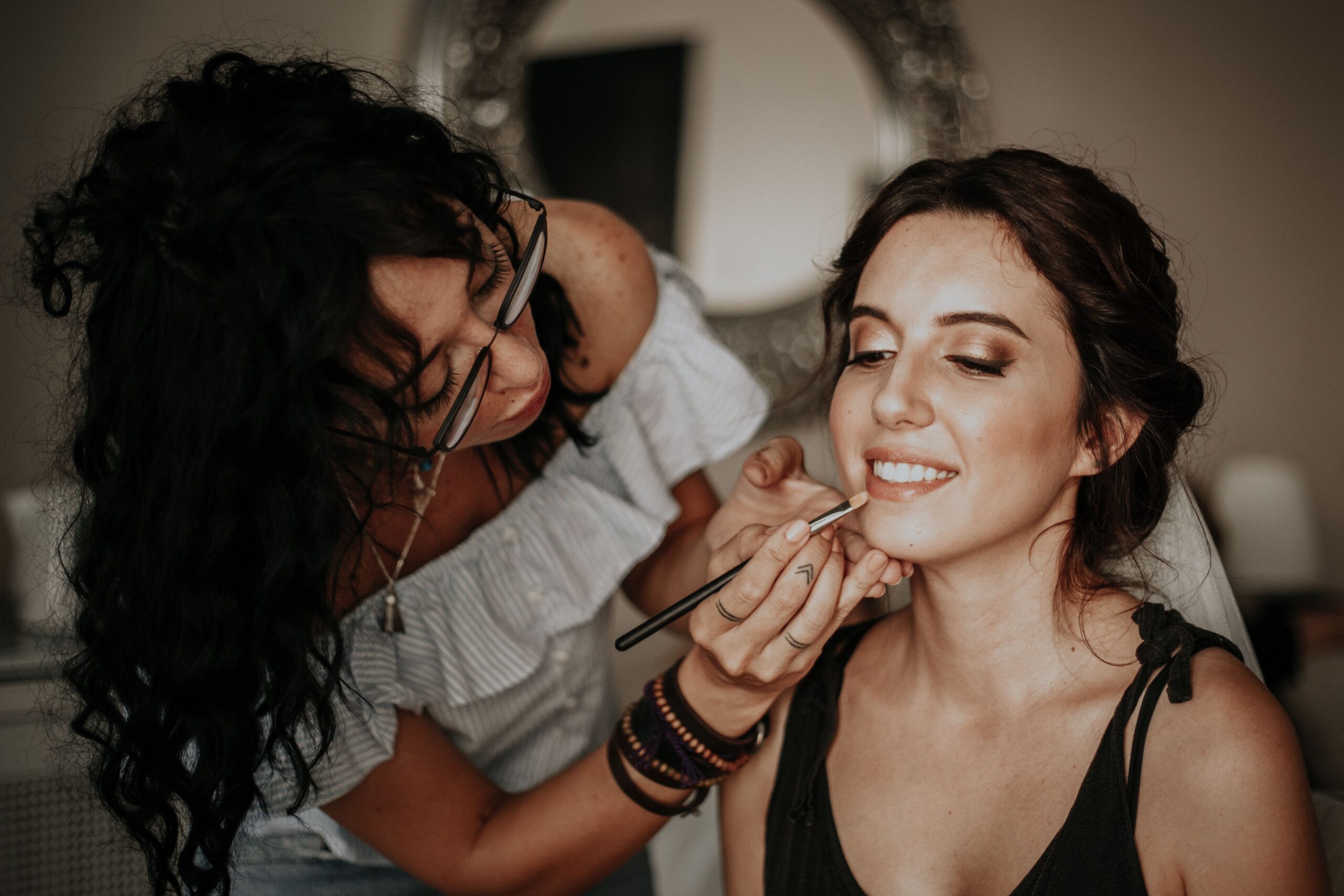 Makeup artist applying evening makeup to a client at the salon