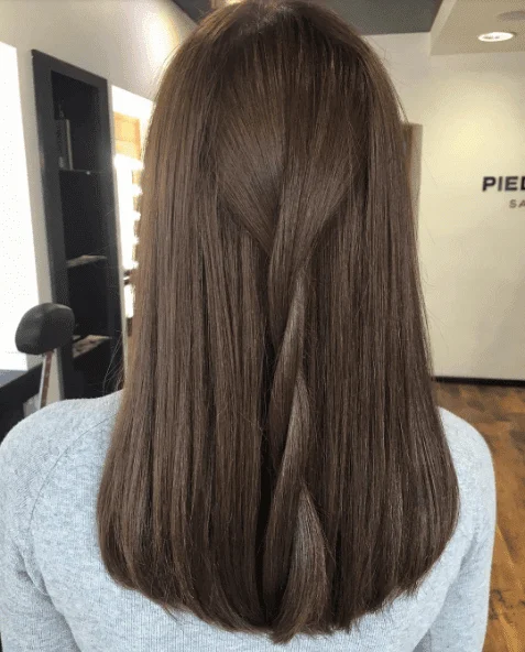 Brown hair sectioned for hair extension removal
